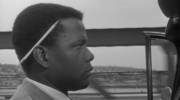 Movie still from “The Slender Thread” (1965), directed by Sydney Pollack – A black and white photo of a young man looking off into the distance; Close Up shot, Over the shoulder angle
