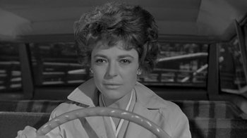 Movie still from “The Slender Thread” (1965), directed by Sydney Pollack – Black and white photograph of a woman driving a car; Close Up shot, Low angle