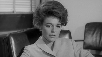 Movie still from “The Slender Thread” (1965), directed by Sydney Pollack – A black and white photo of a woman in a suit; Close Up shot, Low angle