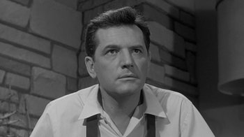 Movie still from “The Slender Thread” (1965), directed by Sydney Pollack – Black and white photograph of a man looking at the camera; Close Up shot, Low angle