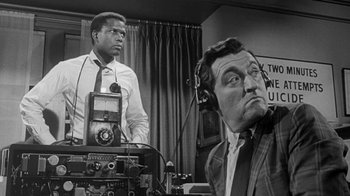Movie still from “The Slender Thread” (1965), directed by Sydney Pollack – A man in a tie and a man in a suit and tie; Medium shot, Low angle