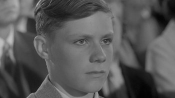 Movie still from “The Slender Thread” (1965), directed by Sydney Pollack – A black and white photo of a young boy; Close Up shot, Over the shoulder angle