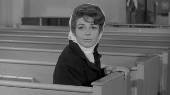 Movie still from “The Slender Thread” (1965), directed by Sydney Pollack – An old photo of a woman sitting in a pew; Medium shot, Low angle