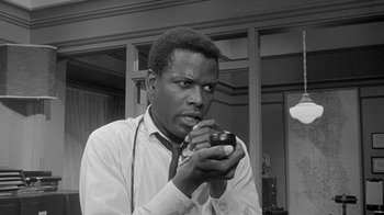 Movie still from “The Slender Thread” (1965), directed by Sydney Pollack – A black and white photo of a man holding a cup; Close Up shot, Low angle