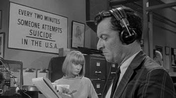 Movie still from “The Slender Thread” (1965), directed by Sydney Pollack – A man and a woman wearing headphones looking at a tablet; Close Up shot, High angle