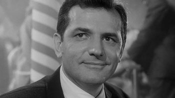 Movie still from “The Slender Thread” (1965), directed by Sydney Pollack – A black and white photo of a man in a suit; Close Up shot, Low angle
