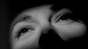 Movie still from “The Slender Thread” (1965), directed by Sydney Pollack – A person's eyes with a black background; Extreme Close Up shot, Overhead angle