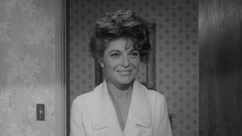 Movie still from “The Slender Thread” (1965), directed by Sydney Pollack – A black and white photo of a woman smiling; Close Up shot, Low angle