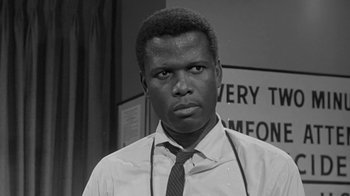 Movie still from “The Slender Thread” (1965), directed by Sydney Pollack – A black and white photo of a man in a tie; Close Up shot, Low angle