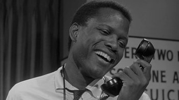 Movie still from “The Slender Thread” (1965), directed by Sydney Pollack – A black and white photo of a man talking on a phone; Close Up shot, Low angle