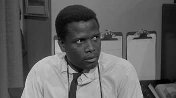Movie still from “The Slender Thread” (1965), directed by Sydney Pollack – A black and white photo of a man wearing a tie; Close Up shot, Over the shoulder angle