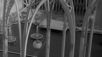 Movie still from “The Slender Thread” (1965), directed by Sydney Pollack – An aerial view of a bridge with a boat in the water; Extreme Wide shot, High angle