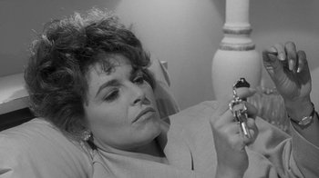 Movie still from “The Slender Thread” (1965), directed by Sydney Pollack – A black - and - white photo of a woman looking at a camera; Close Up shot, High angle