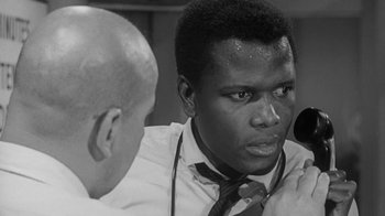 Movie still from “The Slender Thread” (1965), directed by Sydney Pollack – A black and white photo of a man in a tie; Close Up shot, Low angle