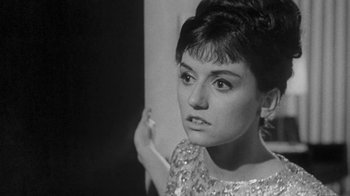 Movie still from “The Slender Thread” (1965), directed by Sydney Pollack – A black - and - white photo of a woman smoking a cigarette; Close Up shot, High angle