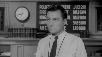 Movie still from “The Slender Thread” (1965), directed by Sydney Pollack – A black - and - white photo of a man in a tie; Close Up shot, Low angle