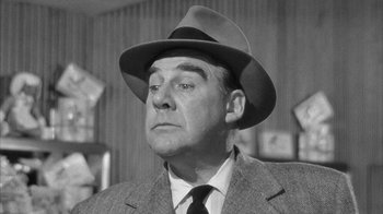 Movie still from “The Solid Gold Cadillac” (1956), directed by Richard Quine – An older man wearing a suit and a hat; Close Up shot, Low angle