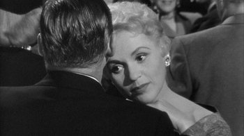 Movie still from “The Solid Gold Cadillac” (1956), directed by Richard Quine – A man and a woman in a black and white photo; Close Up shot, Over the shoulder angle