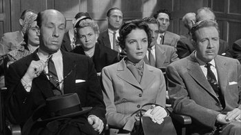 Movie still from “The Solid Gold Cadillac” (1956), directed by Richard Quine – A group of people sitting in a room; Medium shot, High angle