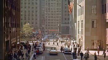 Movie still from “The Solid Gold Cadillac” (1956), directed by Richard Quine – A busy city street filled with people and cars; Extreme Wide shot, High angle