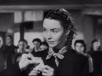 Movie still from “The Song of Bernadette” (1943), directed by Henry King – A woman holding a piece of food in her hands; Close Up shot, Over the shoulder angle