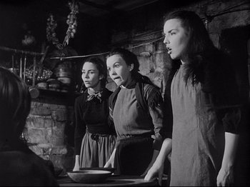 Movie still from “The Song of Bernadette” (1943), directed by Henry King – A group of women standing next to each other in a kitchen; Medium shot, Low angle