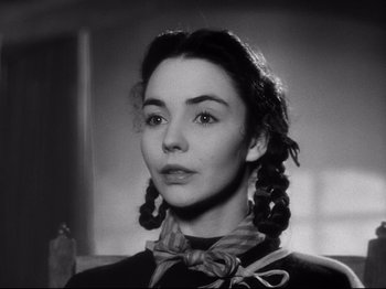 Movie still from “The Song of Bernadette” (1943), directed by Henry King – A black and white photo of a woman with pigtails; Close Up shot, Low angle