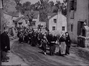 Movie still from “The Song of Bernadette” (1943), directed by Henry King – A group of people walking down a street; Extreme Wide shot, High angle