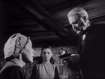 Movie still from “The Song of Bernadette” (1943), directed by Henry King – A man and two women are looking at each other; Medium shot, Low angle