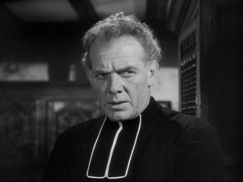 Movie still from “The Song of Bernadette” (1943), directed by Henry King – An older man wearing a priest's collar; Close Up shot, Low angle