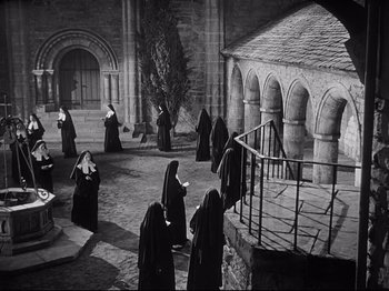 Movie still from “The Song of Bernadette” (1943), directed by Henry King – A black and white photo of a group of nuns; Extreme Wide shot, High angle