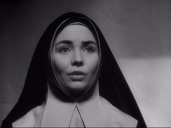 Movie still from “The Song of Bernadette” (1943), directed by Henry King – A woman wearing a nun's habit and a veil; Close Up shot, Low angle