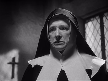 Movie still from “The Song of Bernadette” (1943), directed by Henry King – An old woman wearing a nun's outfit in a black and white photo; Close Up shot, Low angle