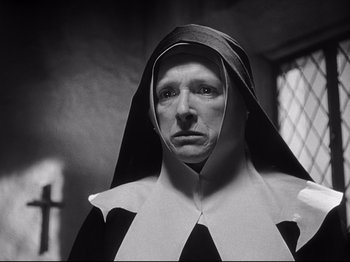 Movie still from “The Song of Bernadette” (1943), directed by Henry King – A nun in a black and white photo wearing a nun's outfit; Close Up shot, Low angle