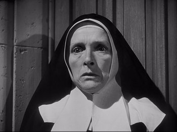 Movie still from “The Song of Bernadette” (1943), directed by Henry King – An older woman wearing a nun's habit and looking sad; Close Up shot, Low angle
