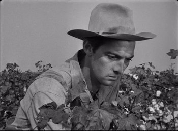 Movie still from “The Southerner” (1945), directed by Jean Renoir – A black and white photo of a man in a hat; Medium shot, Low angle