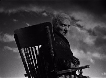 Movie still from “The Southerner” (1945), directed by Jean Renoir – An old woman sitting in a wooden rocking chair; Medium shot, Low angle
