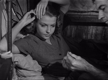 Movie still from “The Southerner” (1945), directed by Jean Renoir – An old photo of a woman getting her hair done; Close Up shot, High angle