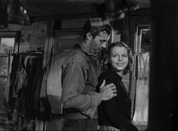 Movie still from “The Southerner” (1945), directed by Jean Renoir – A man and a woman standing next to each other; Medium shot, Over the shoulder angle