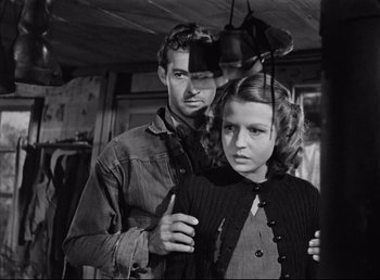 Movie still from “The Southerner” (1945), directed by Jean Renoir – A man and a woman are standing in a room together; Medium shot, Over the shoulder angle