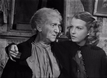 Movie still from “The Southerner” (1945), directed by Jean Renoir – An older man and a younger woman standing next to each other; Medium shot, High angle