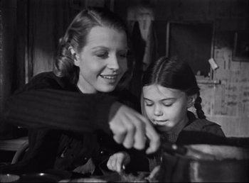 Movie still from “The Southerner” (1945), directed by Jean Renoir – A woman and a girl cooking food in a kitchen; Medium shot, High angle