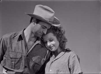 Movie still from “The Southerner” (1945), directed by Jean Renoir – A man and a woman in a cowboy hat; Medium shot, Low angle