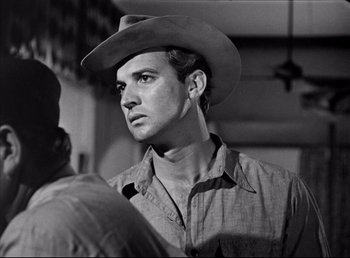 Movie still from “The Southerner” (1945), directed by Jean Renoir – A black and white photo of a man wearing a cowboy hat; Close Up shot, Over the shoulder angle