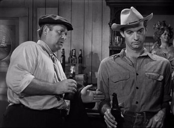 Movie still from “The Southerner” (1945), directed by Jean Renoir – Two men are drinking beer in a bar; Medium shot, Low angle