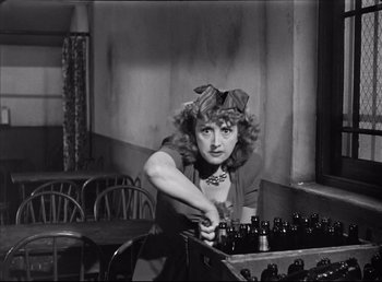 Movie still from “The Southerner” (1945), directed by Jean Renoir – An old photo of a woman working in a factory; Medium shot, High angle
