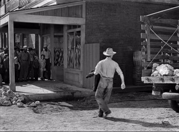Movie still from “The Southerner” (1945), directed by Jean Renoir – An old photo of a man walking in the dirt; Wide shot, Over the shoulder angle
