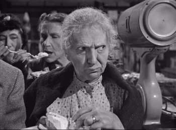 Movie still from “The Southerner” (1945), directed by Jean Renoir – An older woman is holding a piece of cake; Close Up shot, Over the shoulder angle