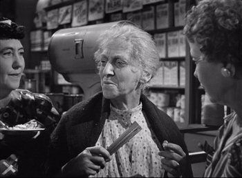 Movie still from “The Southerner” (1945), directed by Jean Renoir – An older woman holding a pair of scissors in her hand; Medium shot, Over the shoulder angle