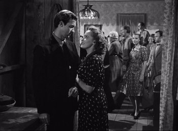 Movie still from “The Southerner” (1945), directed by Jean Renoir – A man and a woman standing next to each other; Medium shot, Over the shoulder angle